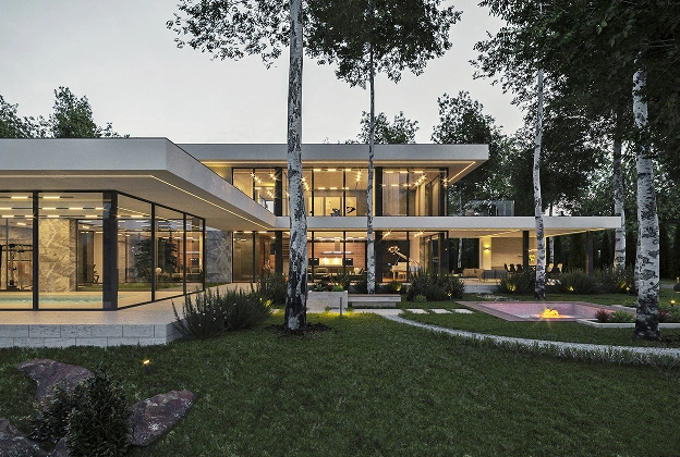 Moderne twee verdiepingen tellende glazen woning te midden van bomen, met warme binnenverlichting en een gezellige sfeer. Een vuurplaats en aangelegde tuin verbeteren de serene omgeving.